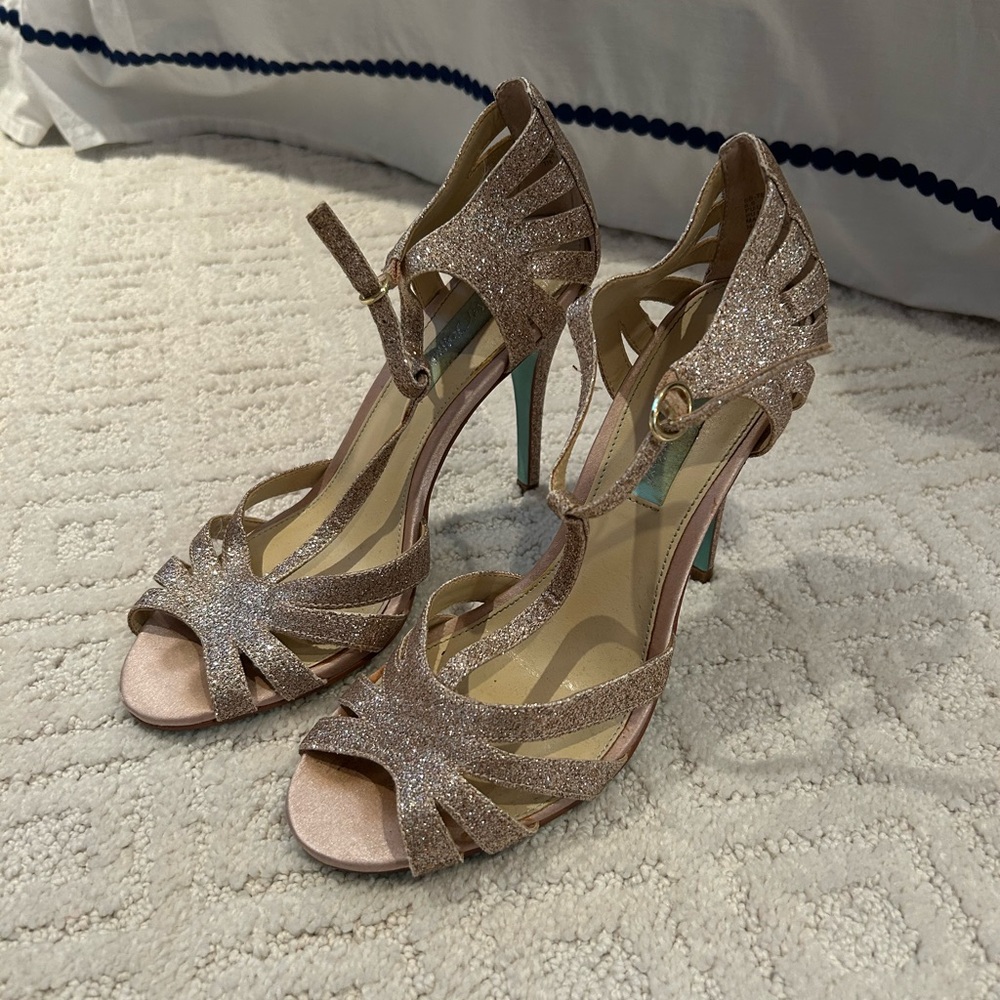 Gold sparkly stiletto heels, blue bottoms